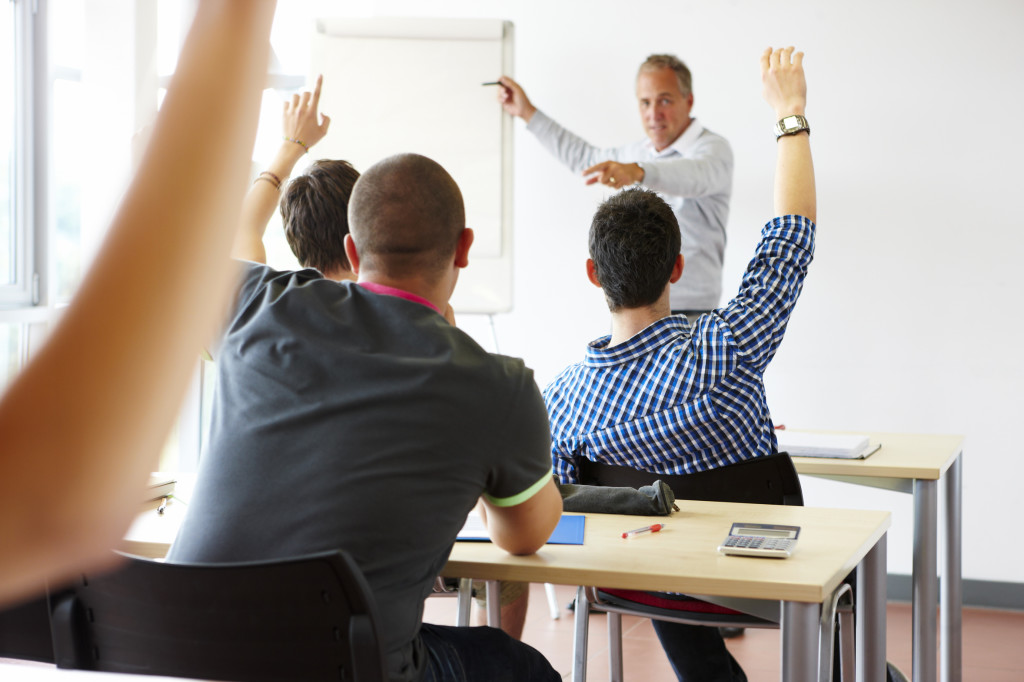 teacher in classroom with eager students